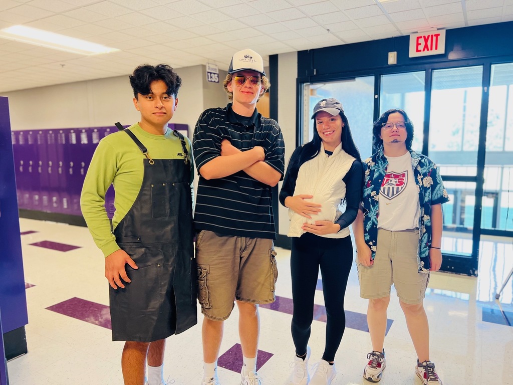 Four students in Soccer mom and grill dad costumes