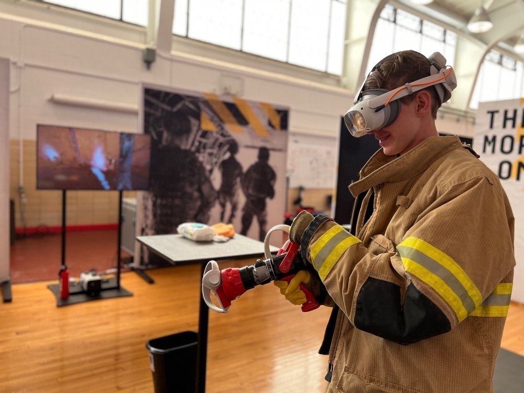 student fighting fires with virtual reality goggles